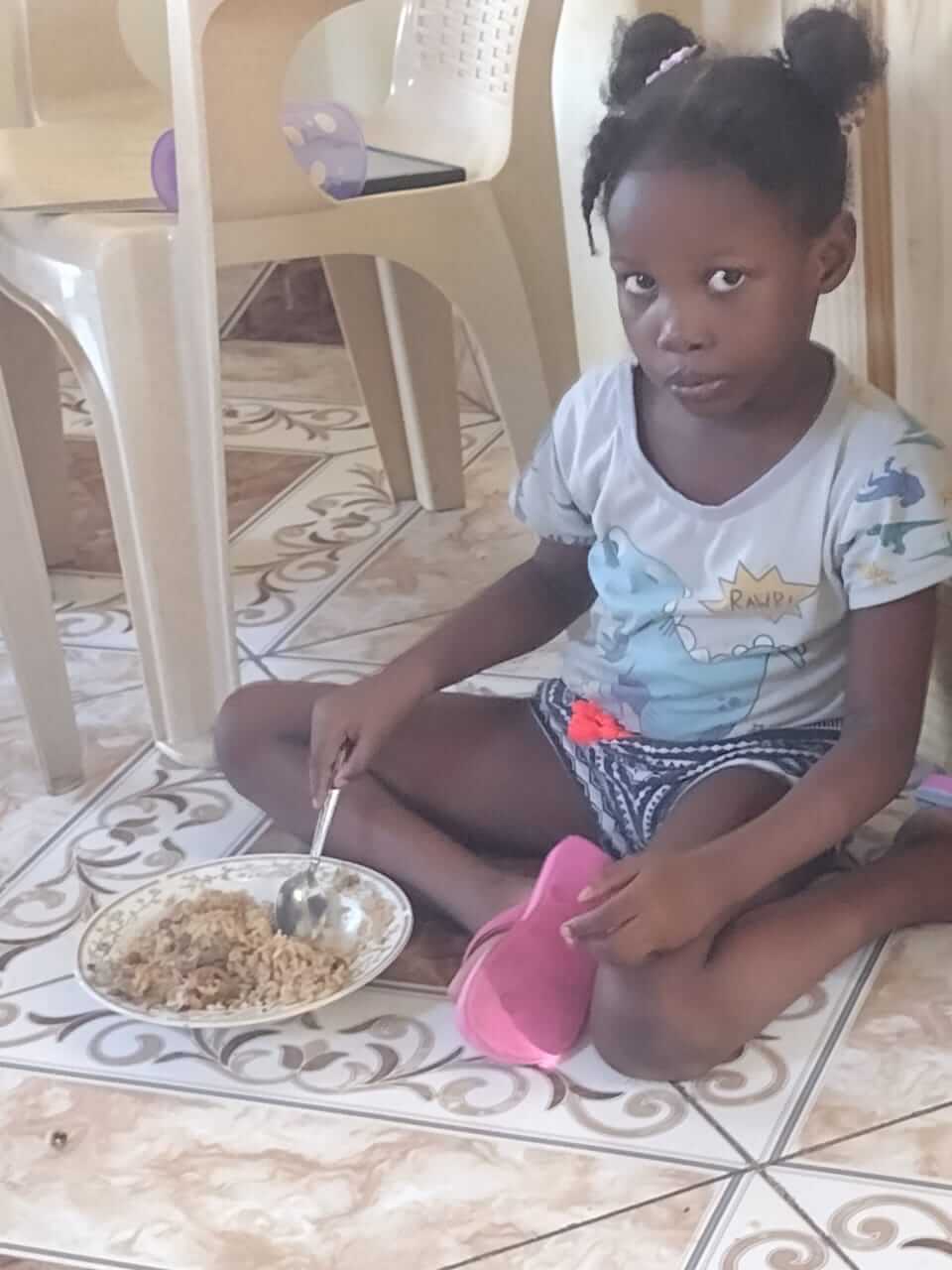 Orphan Child Receiving a Meal